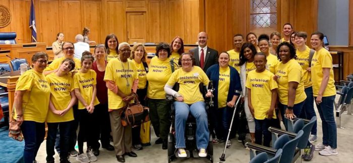 A group of people, many in yellow 