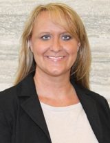A woman with long blonde hair in a black blazer, smiling, represents support for Louisiana citizens with developmental disabilities.